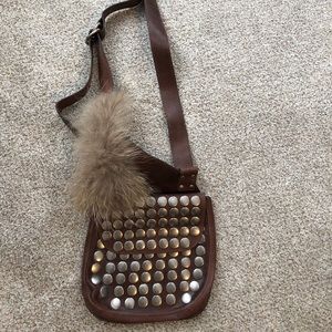 Leather studded bag with fur accent